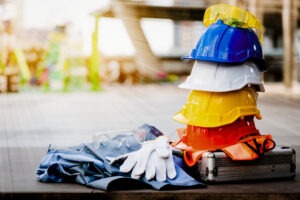 A stack of safety hats and gloves on a construction site